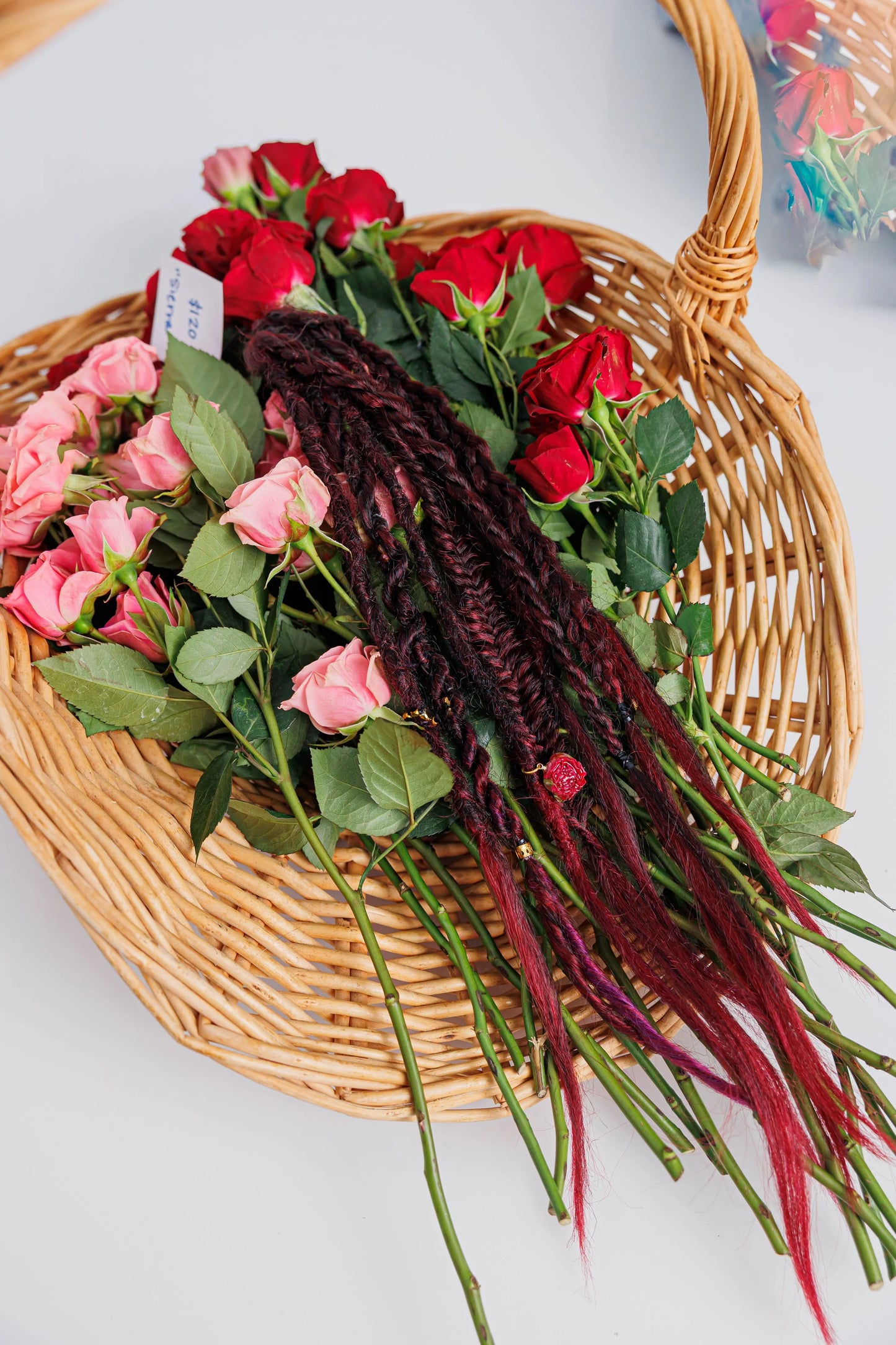 boho braided magenta hair with red and pink roses in a basket