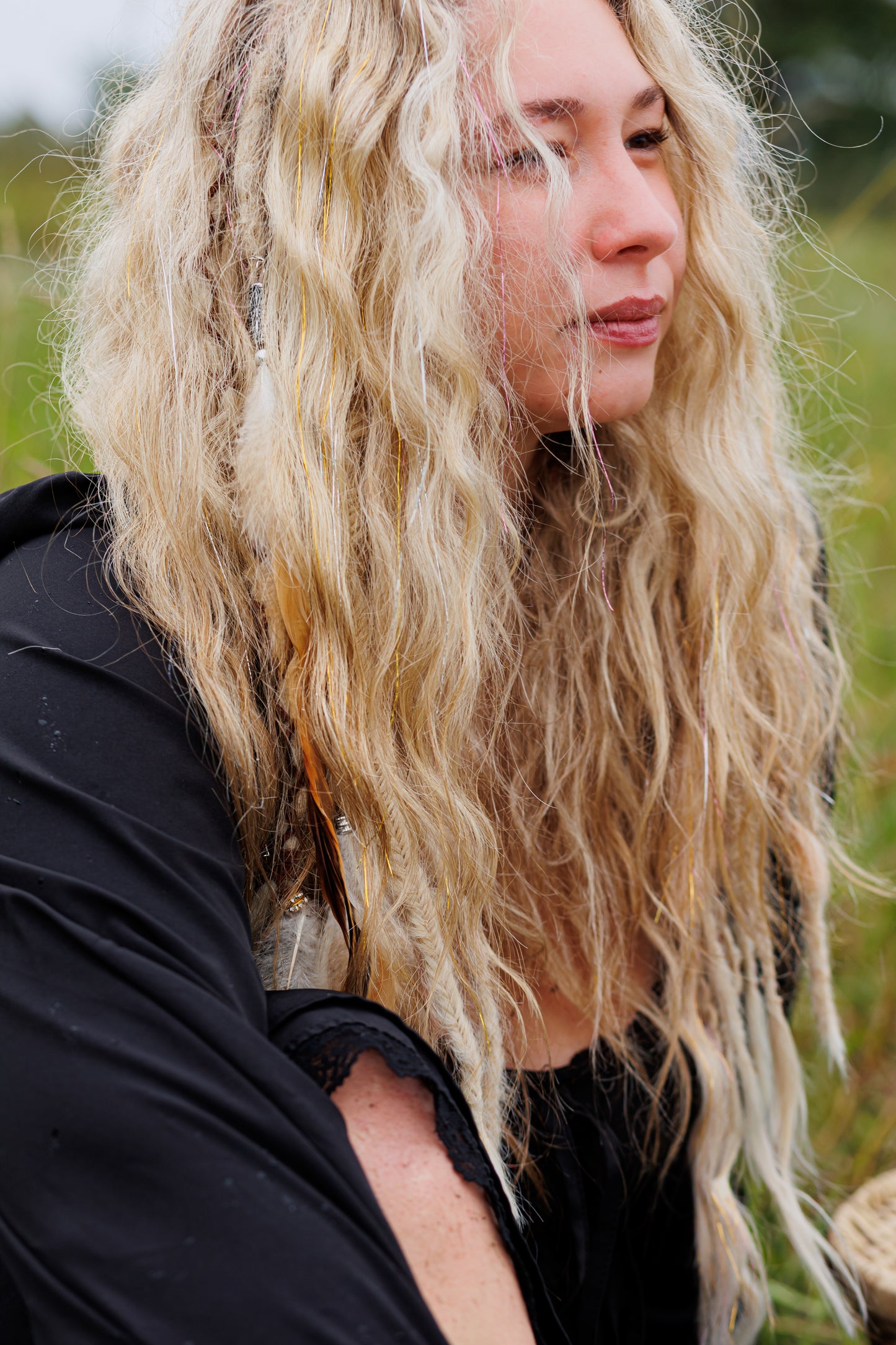 woman with long blonde hair in a natural setting with a boho hair