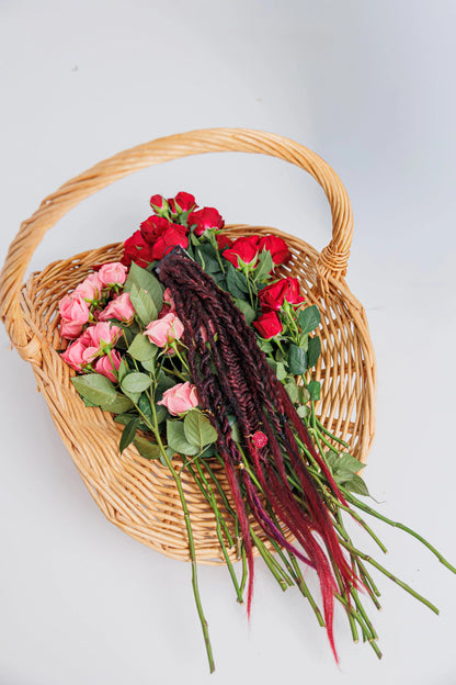 Magenta braid extension in a basket with red and pink roses