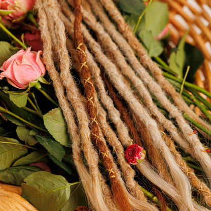 golden blonde and light red textured boho braids with shimmer threads and preserved florals