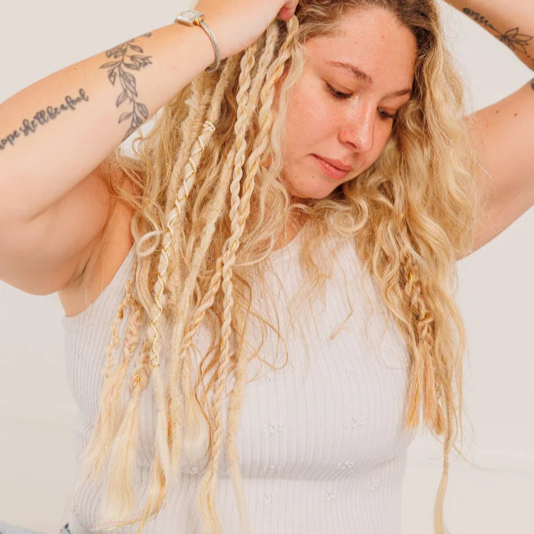 Woman with long blonde hair wearing boho hair extension