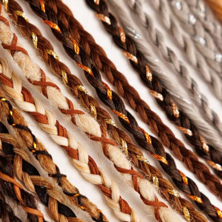 Close-up of braided hair extensions with brown, beige, and gold colors.