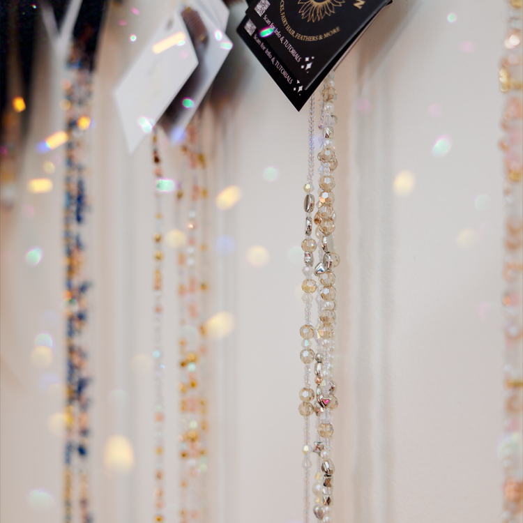 Beaded fairy chains on a hanger with 'Fairy Hair Garden' packaging in the background.