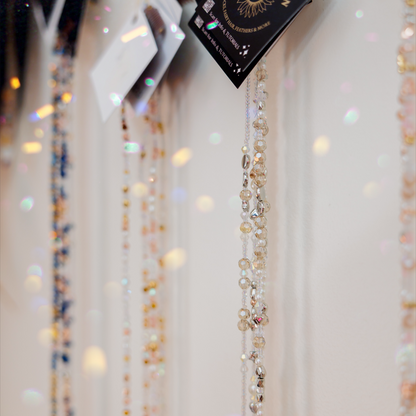 Beaded fairy chains on a hanger with 'Fairy Hair Garden' packaging in the background.
