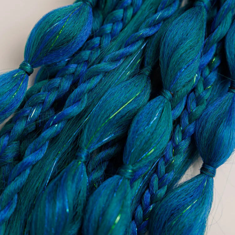 Close-up of blue braided hair extensions on a light background