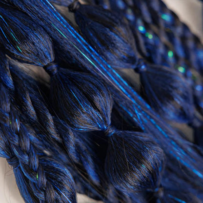 Close-up of blue braided hair extensions on a white background