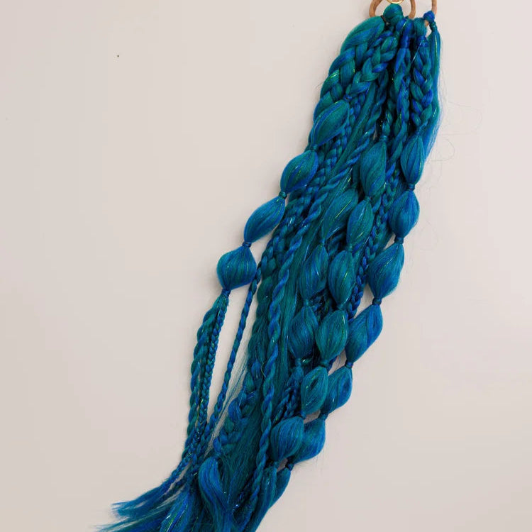 Blue braided yarn with tassels on a white background