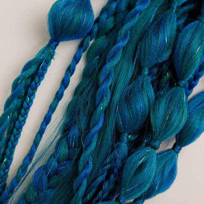 Close-up of blue braided hair extensions on a light background