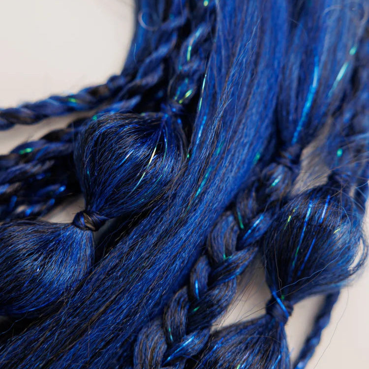 Close-up of blue braided hair extensions on a white background