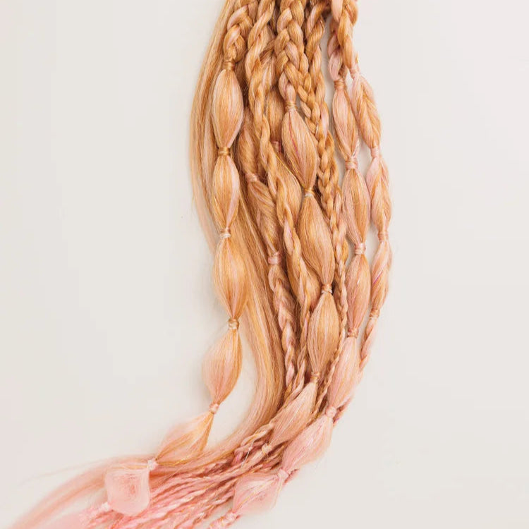 Braided hair extensions with pink tassels on a white background