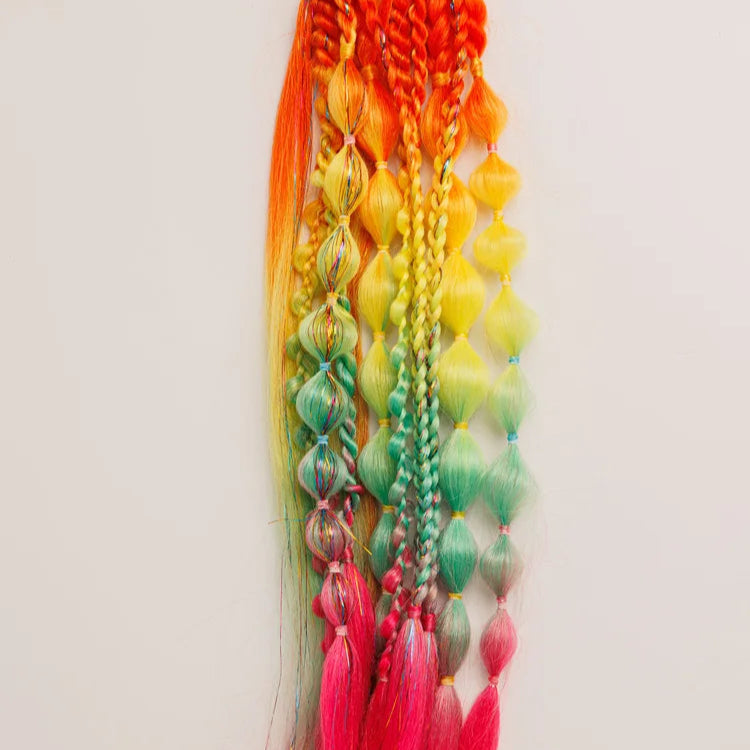 Colorful braided hair extensions with beads and feathers on a white background