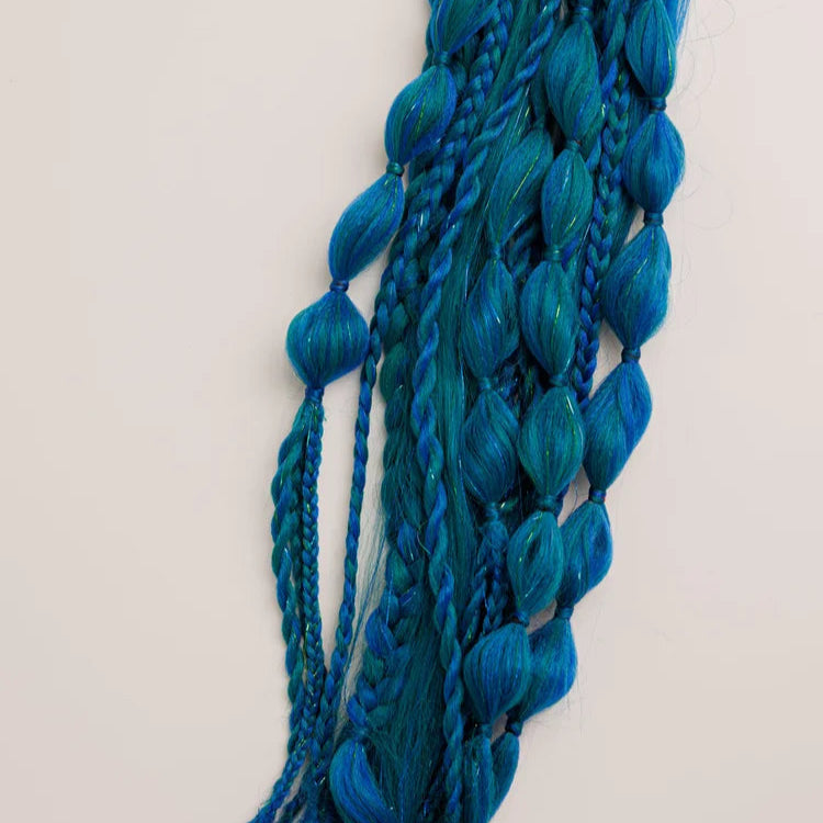 Blue braided hair extensions on a white background