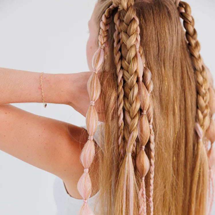 Person with braided hair featuring pink beads on a white background