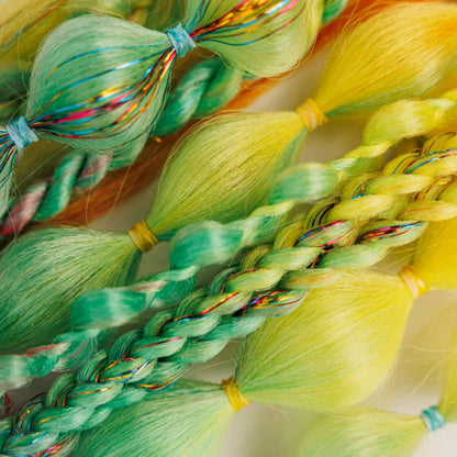 Colorful braided hair with beads on a white background