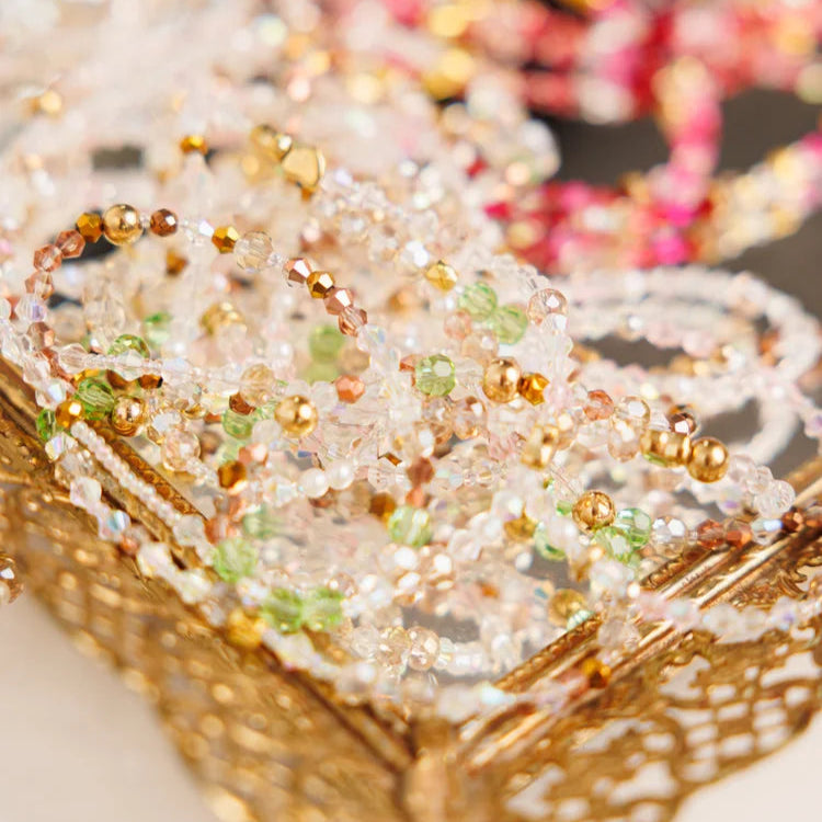 Close-up of beaded bracelets on a decorative box with a blurred background