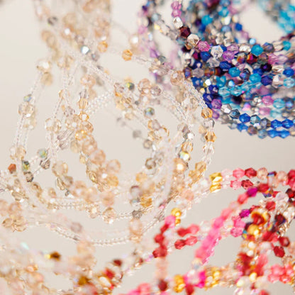 Close-up of multicolored beaded strands on a light background
