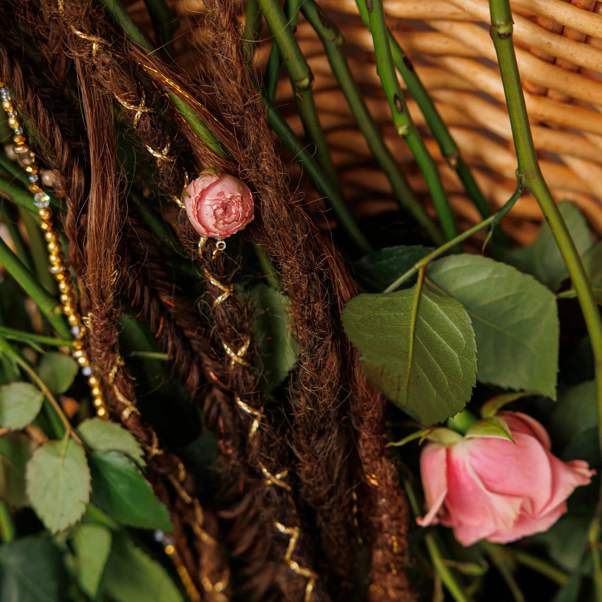 dark and medium brown textured braids with soft shimmer and preserved rose details