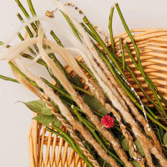 temporary blonde dreadlocks and braids in a basket of rose stems