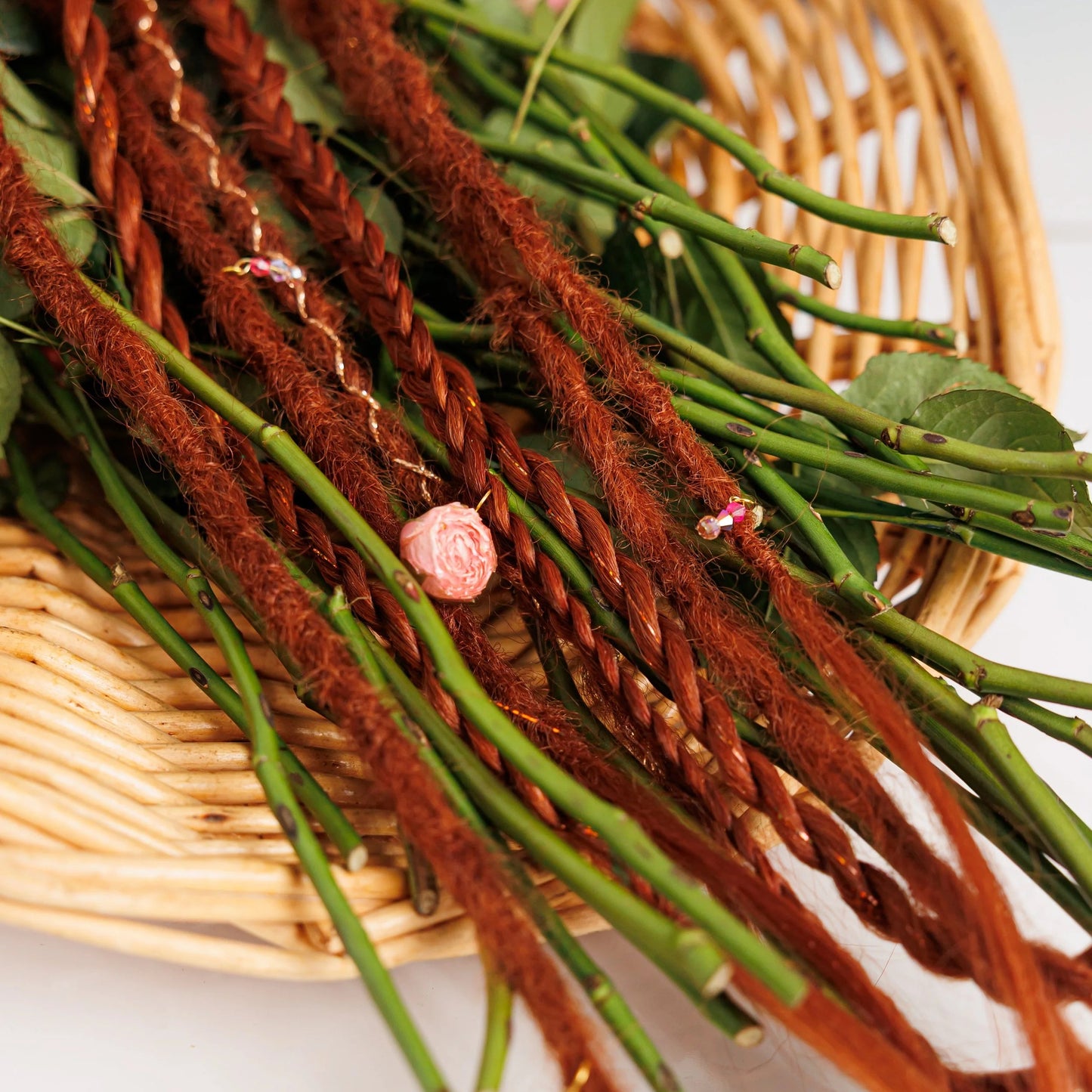 deep red 28-inch boho hair extensions with subtle shimmer in a basket